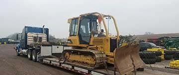 Tracked dozer secured on a step-deck trailer